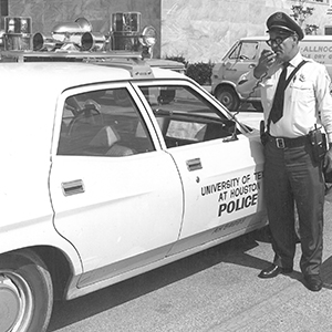 Archival photograph of UT Police officer calling in to dispatch center
