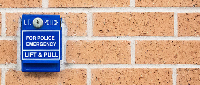 Close-up of brick wall with attached Police Emergency Callbox
